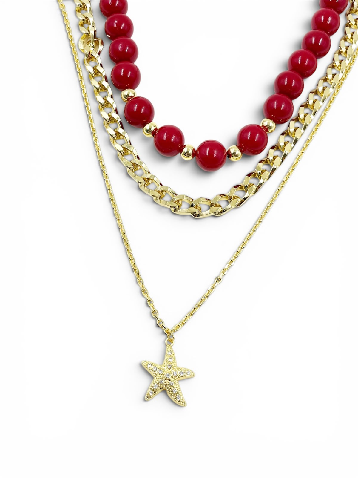 Collar Tres Maravillas Gold Vino con diseño de capas, detalles decorativos y dije de estrella de mar.