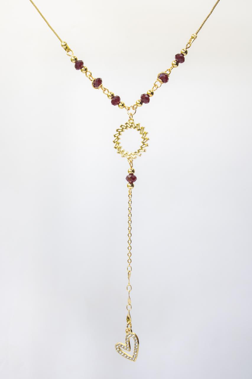 Collar Eterna Esencia en rodio dorado con cristales dorados y microcircones transparentes, diseño tipo corbatín elegante sobre fondo blanco.