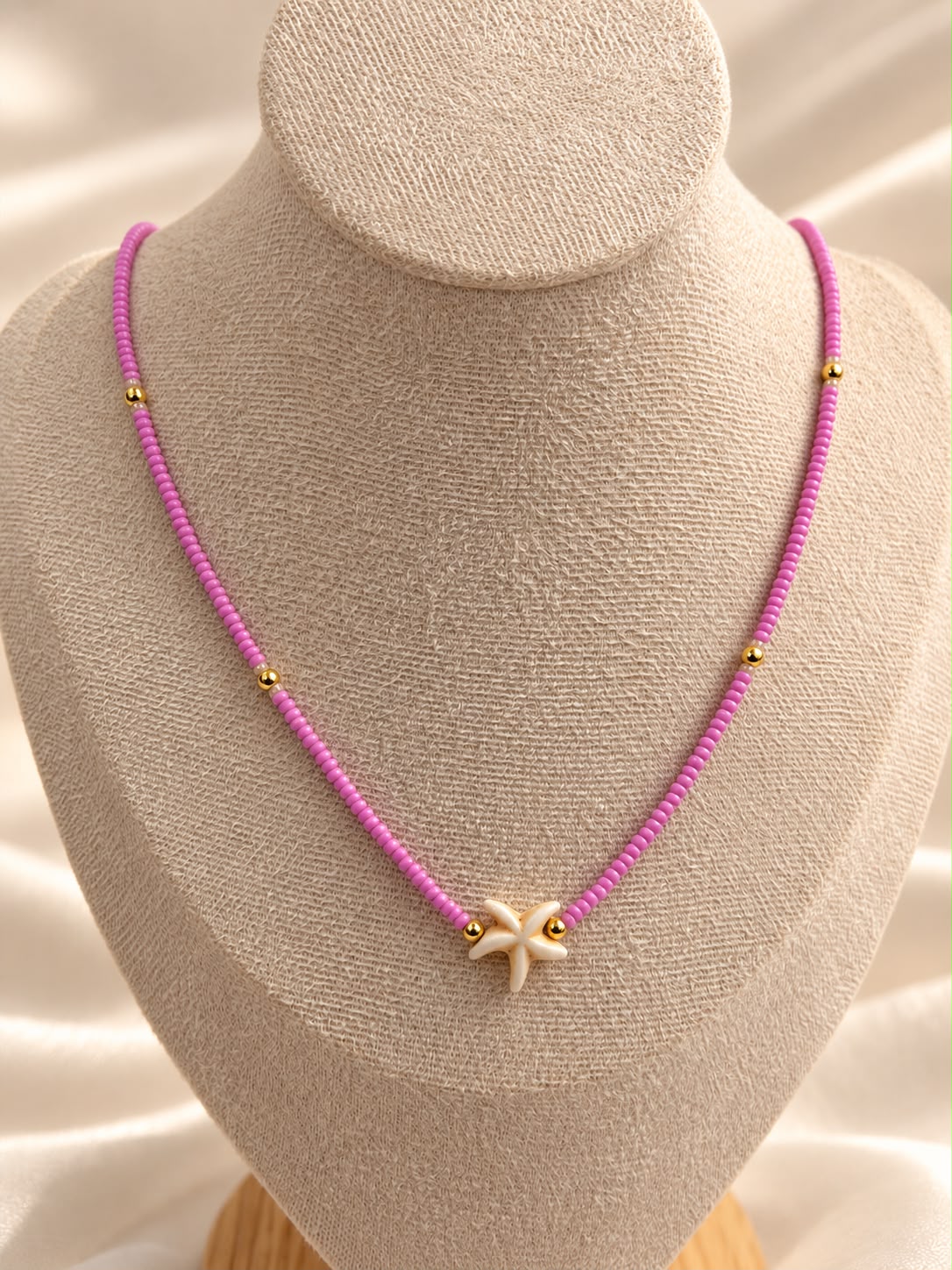 Collar de cuentas con dije central en forma de estrella de mar.