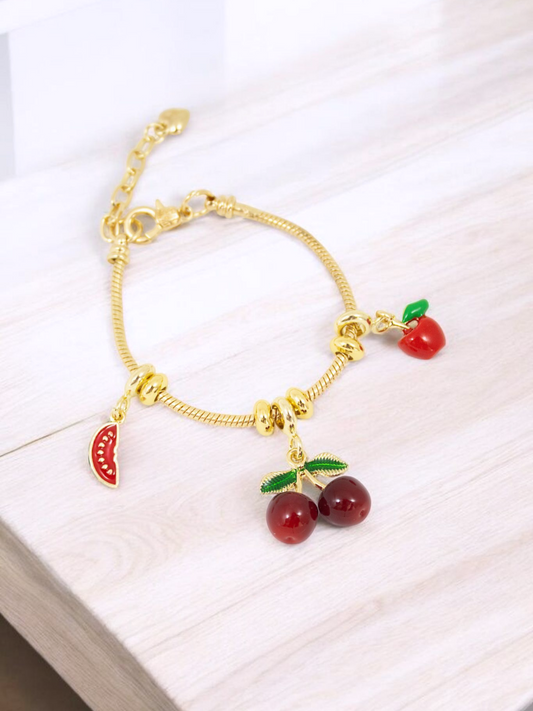 Pulsera Sweet Temptation Guaya Metálica rodinada con dijes de frutas cereza, manzana y sandía