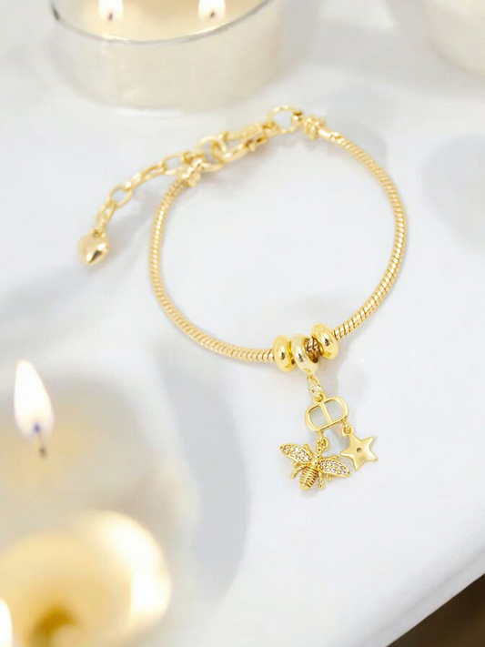 Pulsera Honey Guaya Dorada rodinada con multi dijes pintados y cadena ajustable