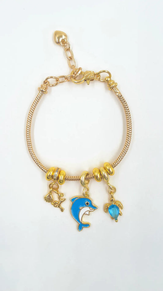 Pulsera Charms Delfín en guaya metálica rodinada con dije delfín pintado y dijes rodinados