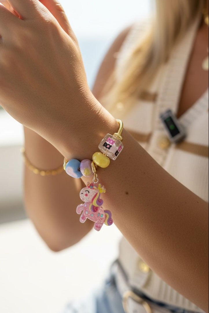 Pulsera de guaya dorada con dijes de resina y dije de pony que brilla en la oscuridad
