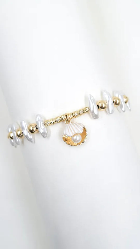 Pulsera Concha en guaya rodinada con dije concha y perla incrustada